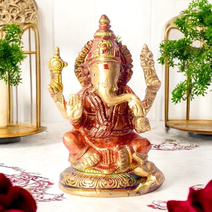 Small vibrant colored brass Ganesh statue, beautifully adorned with bright colors, symbolizing prosperity and remover of obstacles. Perfect for pooja rooms and spiritual spaces. India’s Largest Pooja Accessories Brand – www.satvikworld.com