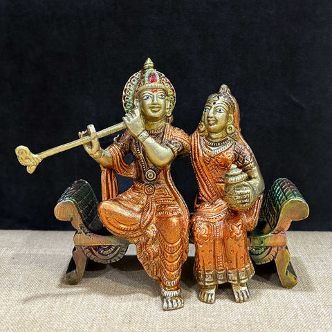 Graceful 4.7 inch brass idol of Radha and Krishna seated on a decorative bench, exuding divine charm and intricate detailing. A spiritual masterpiece in radiant finish. India’s Largest Pooja Accessories Brand – www.satvikworld.com