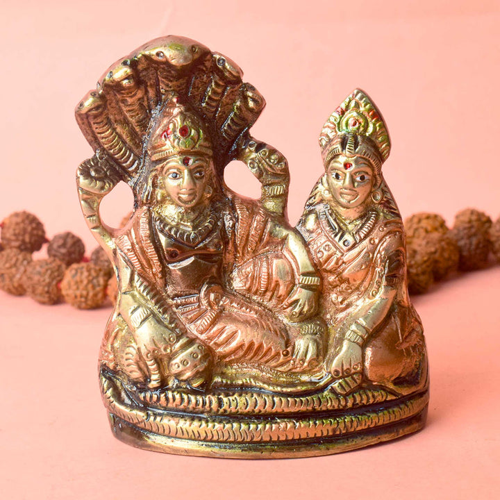 3.7-inch small brass Vishnu Ji idol, depicting Lord Vishnu resting on the divine serpent Shesnag, intricately crafted to symbolize cosmic balance, preservation, and divine protection. Ideal for worship or spiritual décor. India’s Largest Pooja Accessories Brand – www.satvikworld.com