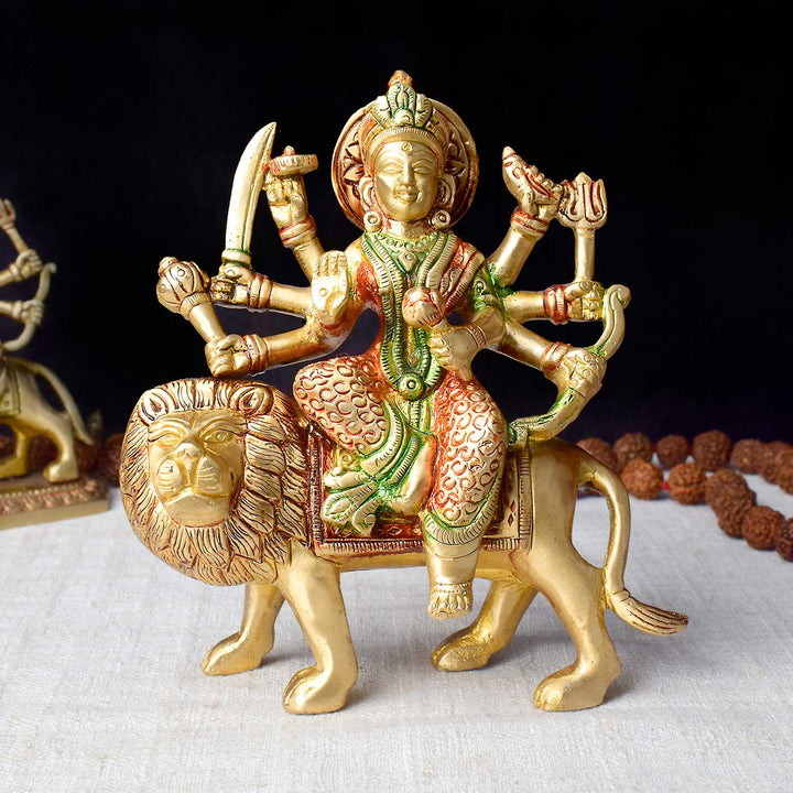 5.5-inch brass Durga idol seated on a lion, symbolizing power and divine protection, ideal for Navratri puja and spiritual celebrations. Perfect for pooja rooms and festive decor. India’s Largest Pooja Accessories Brand – www.satvikworld.com