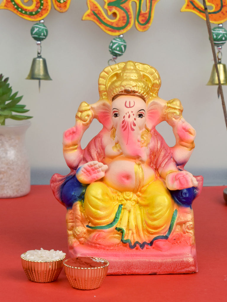 6-inch colorful eco-friendly Ganesha idol sitting on a decorative shinghasan, handcrafted from natural clay and painted with vibrant, non-toxic colors. India’s Largest Pooja Accessories Brand – www.satvikworld.com