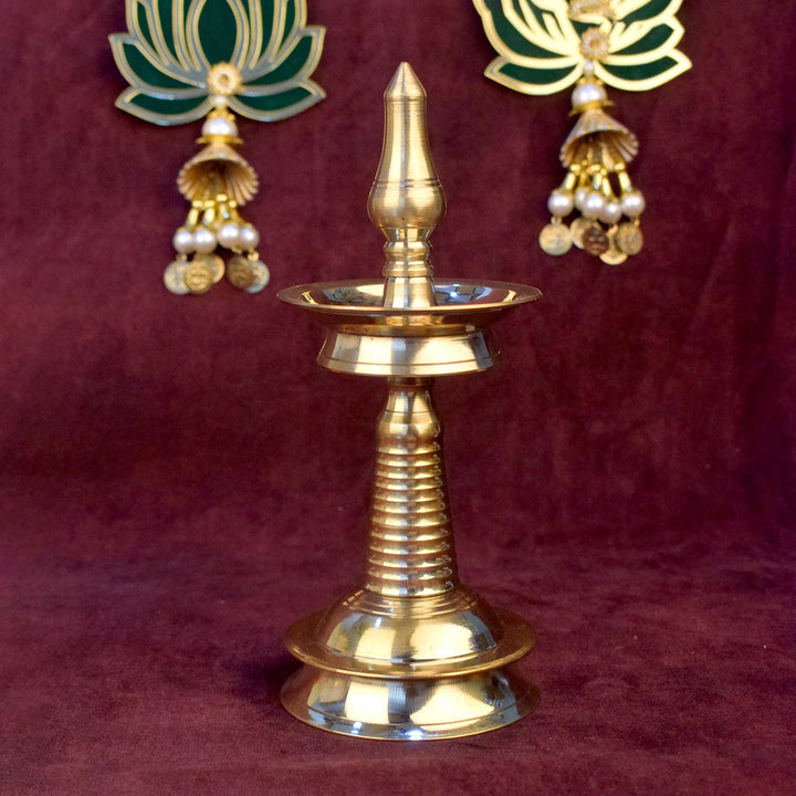 7.5 inch small brass Kerala diya (AKP Nilavilakku Deepam) traditional South Indian oil lamp for pooja and temple decor. 
India’s Largest Pooja Accessories Brand – www.satvikworld.com
