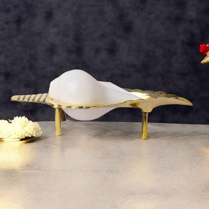 8 inch beautifully crafted brass Shankh (conch) stand with detailed traditional motifs, ideal for showcasing conch shells in puja rooms and sacred spaces. India’s Largest Pooja Accessories Brand – www.satvikworld.com