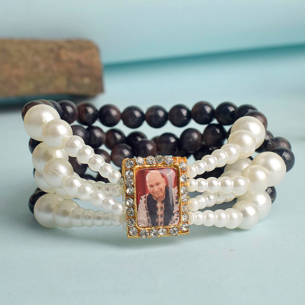 Black with White Pearl Four Layer Guruji Swaroop Bracelet featuring elegant black beads accented with luminous white pearls and Jai Guruji Swaroop – perfect for spiritual wear, festive gifting, and daily devotion. India’s Largest Pooja Accessories Brand – www.satvikworld.com