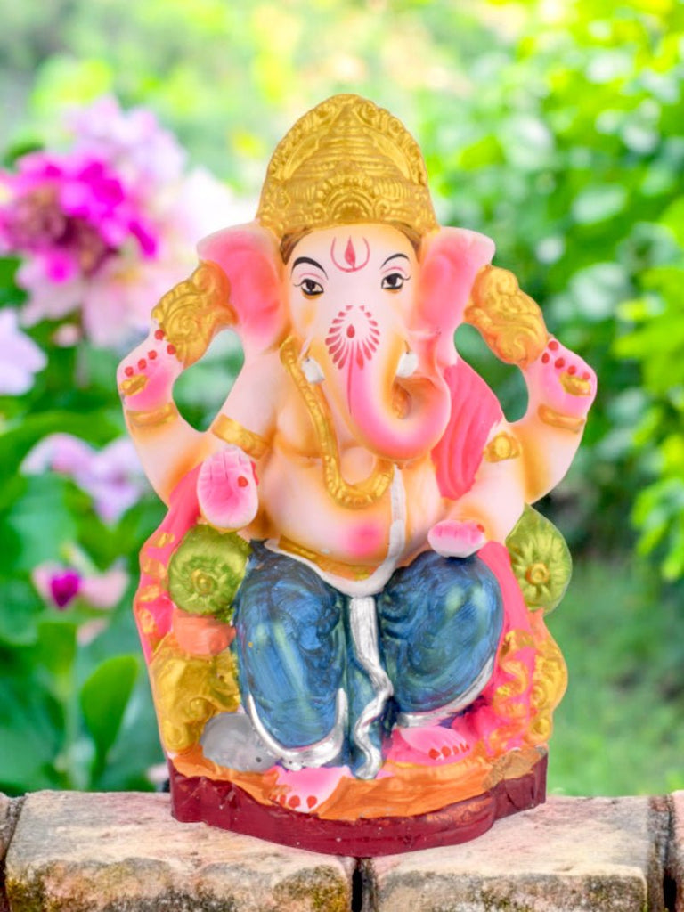 9 Inch Eco-Friendly Ganesh Ji idol seated on a decorative throne, crafted from Shadu clay with intricate detailing. India’s Largest Pooja Accessories Brand – www.satvikworld.com