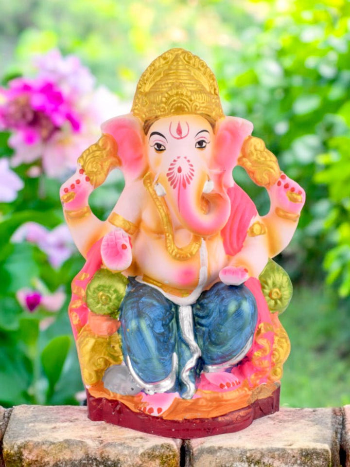 9 Inch Eco-Friendly Ganesh Ji idol seated on a decorative throne, crafted from Shadu clay with intricate detailing. India’s Largest Pooja Accessories Brand – www.satvikworld.com
