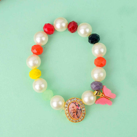Guruji Swaroop Bracelet with pearls, multicoloured beads, and butterfly charm – ideal for satsangs, spiritual wear, or gifting. India’s Largest Pooja Accessories Brand – www.satvikworld.com