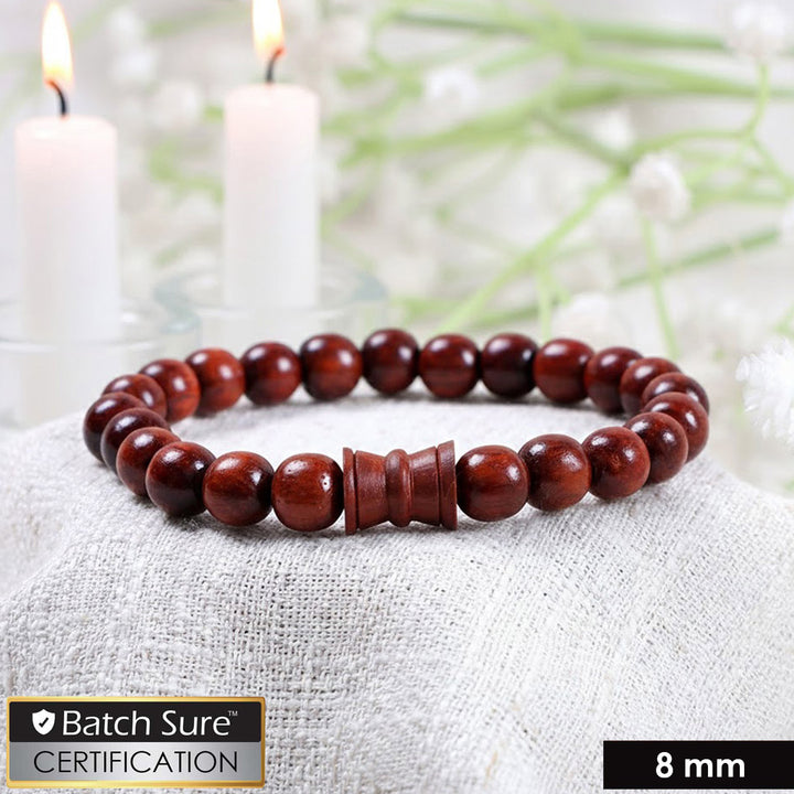 8mm red sandalwood bead bracelet with a central damru-shaped wooden bead on an elastic cord, shown against a neutral background. India’s Largest Puja Accessories Brand- www.satvikworld.com