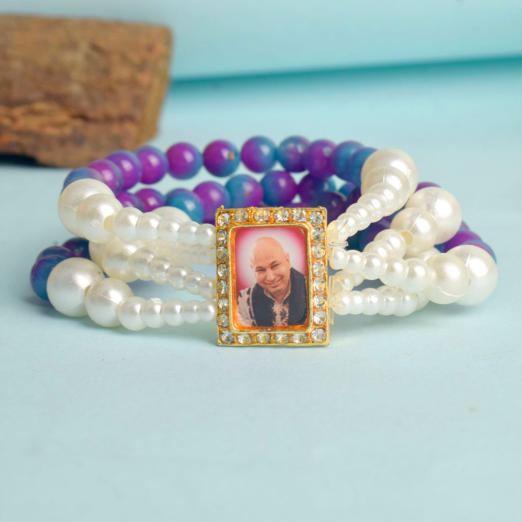 Purple & Blue with White Pearl Four Layer Guruji Swaroop Bracelet featuring rich purple and blue beads accented with luminous white pearls and Jai Guruji Swaroop – perfect for spiritual wear, festive gifting, and daily devotion. India’s Largest Pooja Accessories Brand – www.satvikworld.com