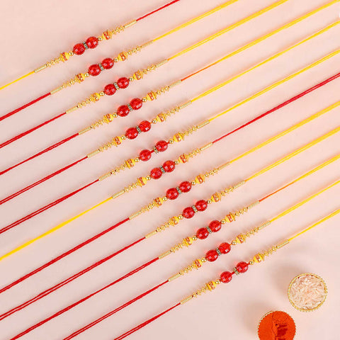 Assortment of 12 Rakhis, featuring different designs, threads, and embellishments for Raksha Bandhan. India’s Largest Pooja Accessories Brand - www.satvikworld.com