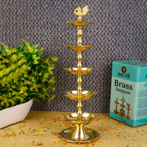 Image Alt Text:
Brass 5 Step Peacock Kerala Diya – Exquisite five-tiered brass diya with detailed peacock top, designed for traditional pooja ceremonies and temple decor. India’s Largest Pooja Accessories Brand – www.satvikstore.in