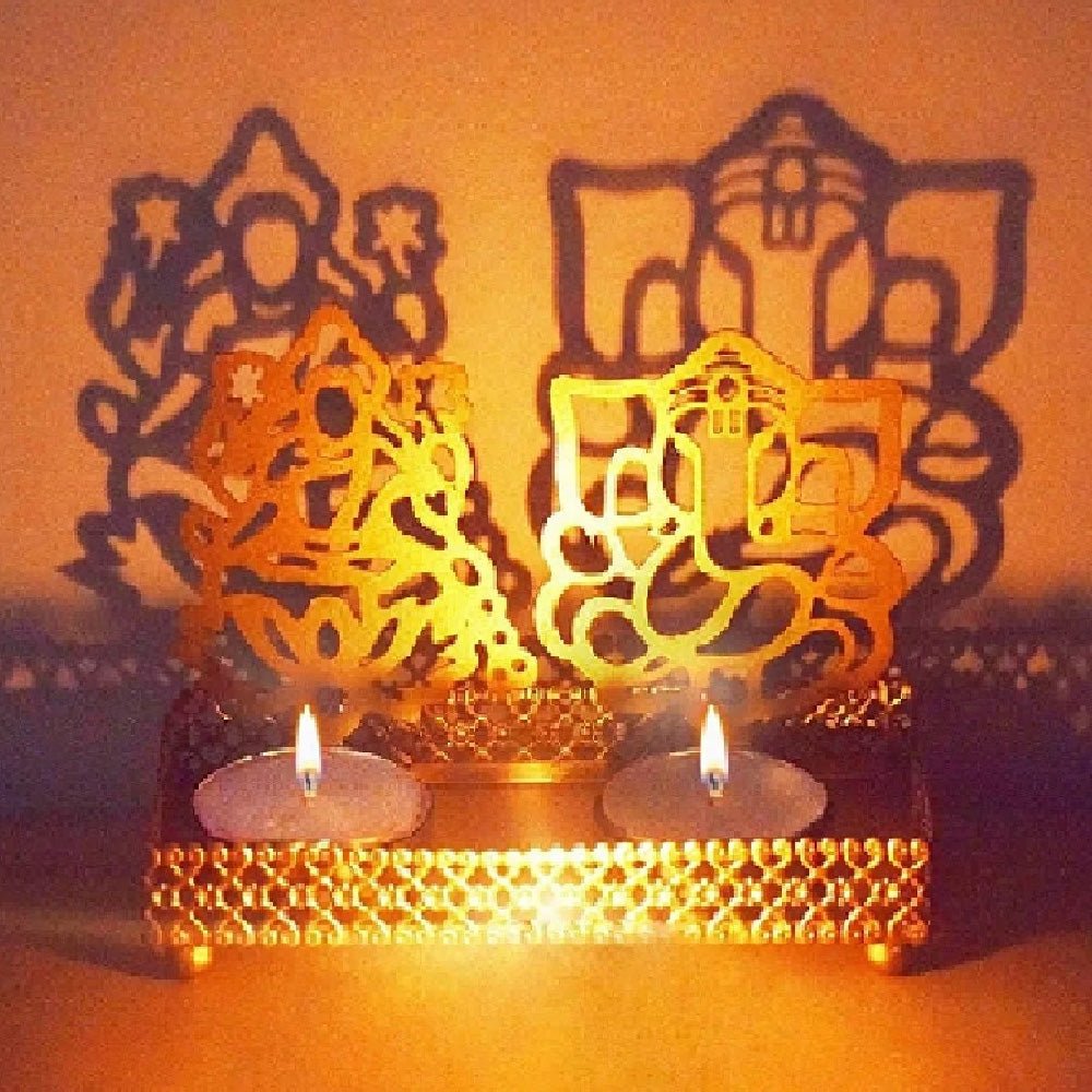 Decorative Lord Ganesh and Lakshmi Shadow Diya, crafted with intricate detailing of the divine deities, creates beautiful shadows, ideal for pooja ceremonies, festivals, and spiritual settings. India’s Largest Pooja Accessories Brand – www.satvikworld.com