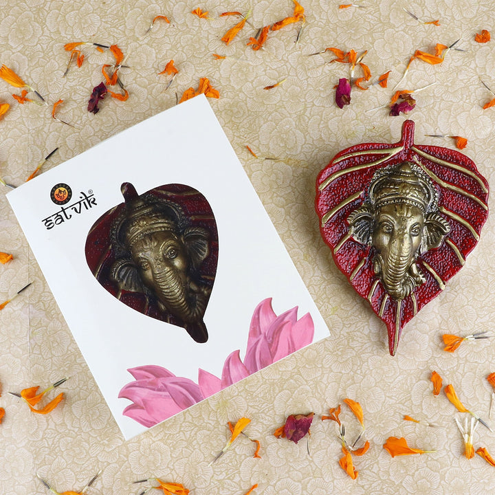 Decorative Lord Ganesh face crafted on green leaf patta wall hanging for spiritual home decor and festive use. India’s Largest Pooja Accessories Brand – www.satvikworld.com