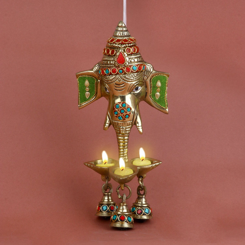 Brass Ganesh face wall hanging with bell and intricate stone work, designed to bring blessings of wisdom, prosperity, and success. Perfect for adorning your home, pooja room, or entrance. India’s Largest Pooja Accessories Brand – www.satvikworld.com