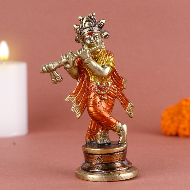 Aesthetic colorful brass idol of Lord Krishna, beautifully crafted with vibrant colors and intricate details, depicting the deity playing his flute. Symbolizing divine music and grace, perfect for spiritual décor or puja rituals. India’s Largest Pooja Accessories Brand – www.satvikworld.com